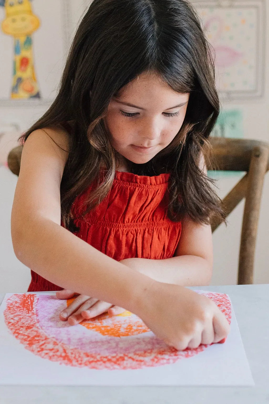 Girl shading a rainbow with a Beeswax Block Crayon