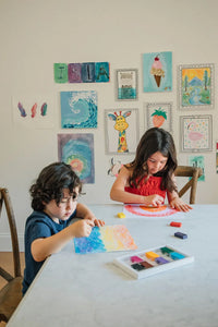 Two kids coloring rainbows together with Beeswax Block Crayons