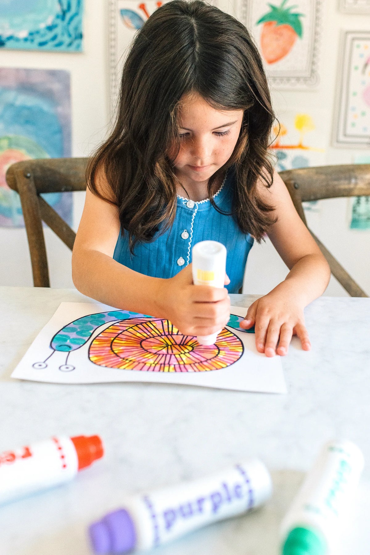 Girl dotting a snail page with an Ultra Bright Shimmer Dot Marker